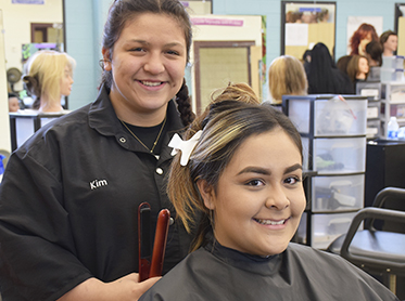 Cosmetology student and client in salon.